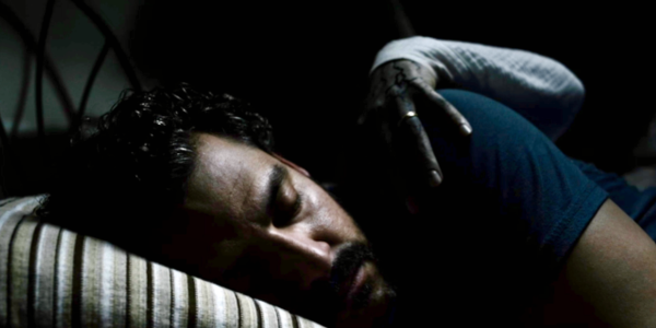 Kenneth Trujillo (as Richard) asleep as a grim hand grabs him.