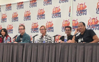 five people sitting at a table, the LA Comic Con logo on banners behind them