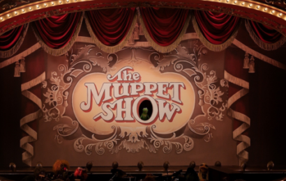 A theatre marquee with The Muppet Show on a screen in the middle.. Kermit is in the O.