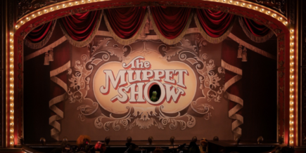 A theatre marquee with The Muppet Show on a screen in the middle.. Kermit is in the O.
