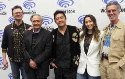 five people in front of a WonderCon banner: two white men, an Asian man, an Asian woman, and a white man