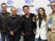 five people in front of a WonderCon banner: two white men, an Asian man, an Asian woman, and a white man
