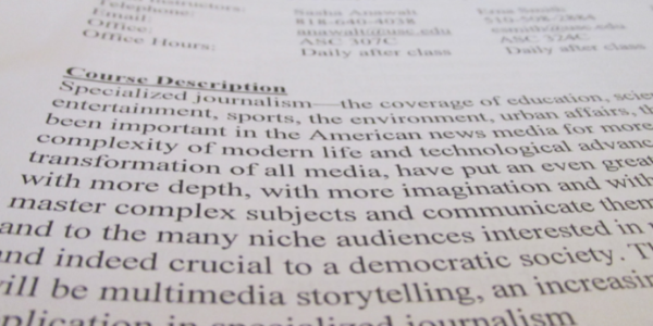 a photo of a syllabus. Text is at an angle, but reads Course Description: Specialized journalism.