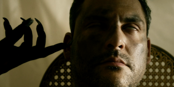 Kenneth Trujillo (as Richard) in a trance as The Crone touches his face.